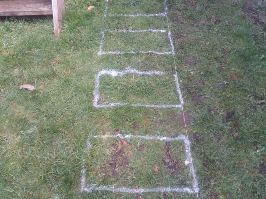 Marking out stepping stones with spray paint