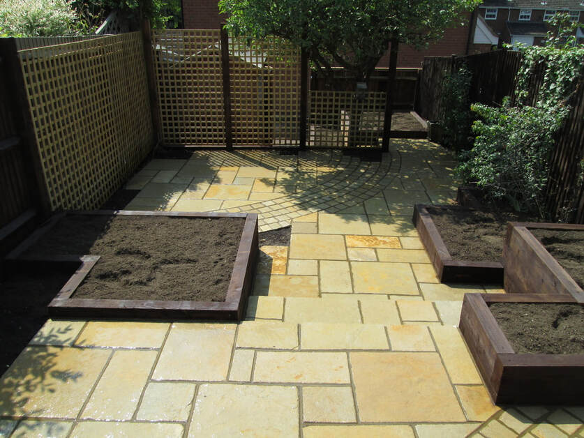 Indian sandstone patio with sleeper raised beds, Rickmansworth