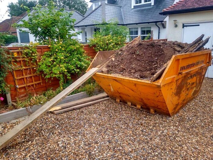 Filling skips with soil