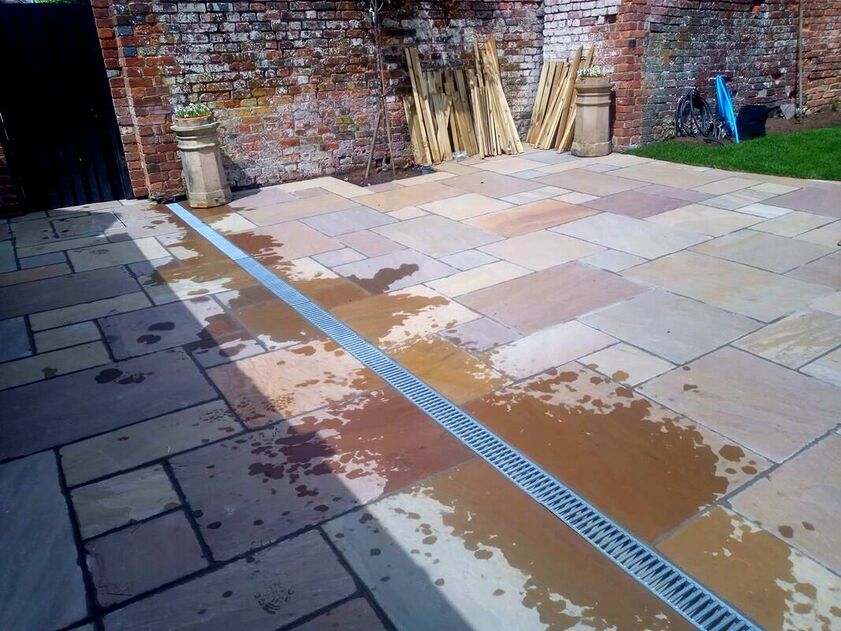Sandstone patio with a drainage channel 