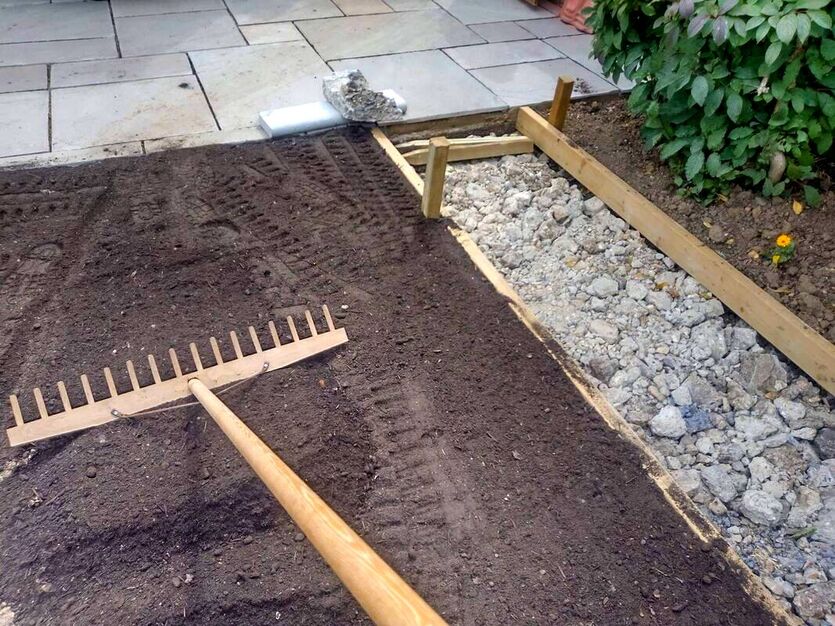 Levelling topsoil with rake